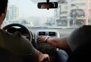 two person riding vehicle during daytime