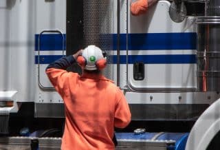 man standing in front of freight truck