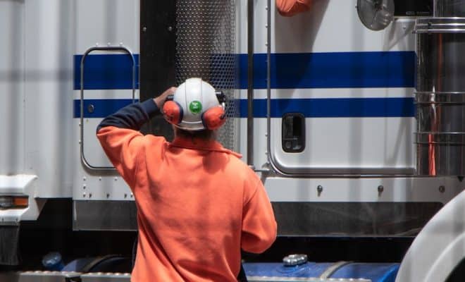 man standing in front of freight truck